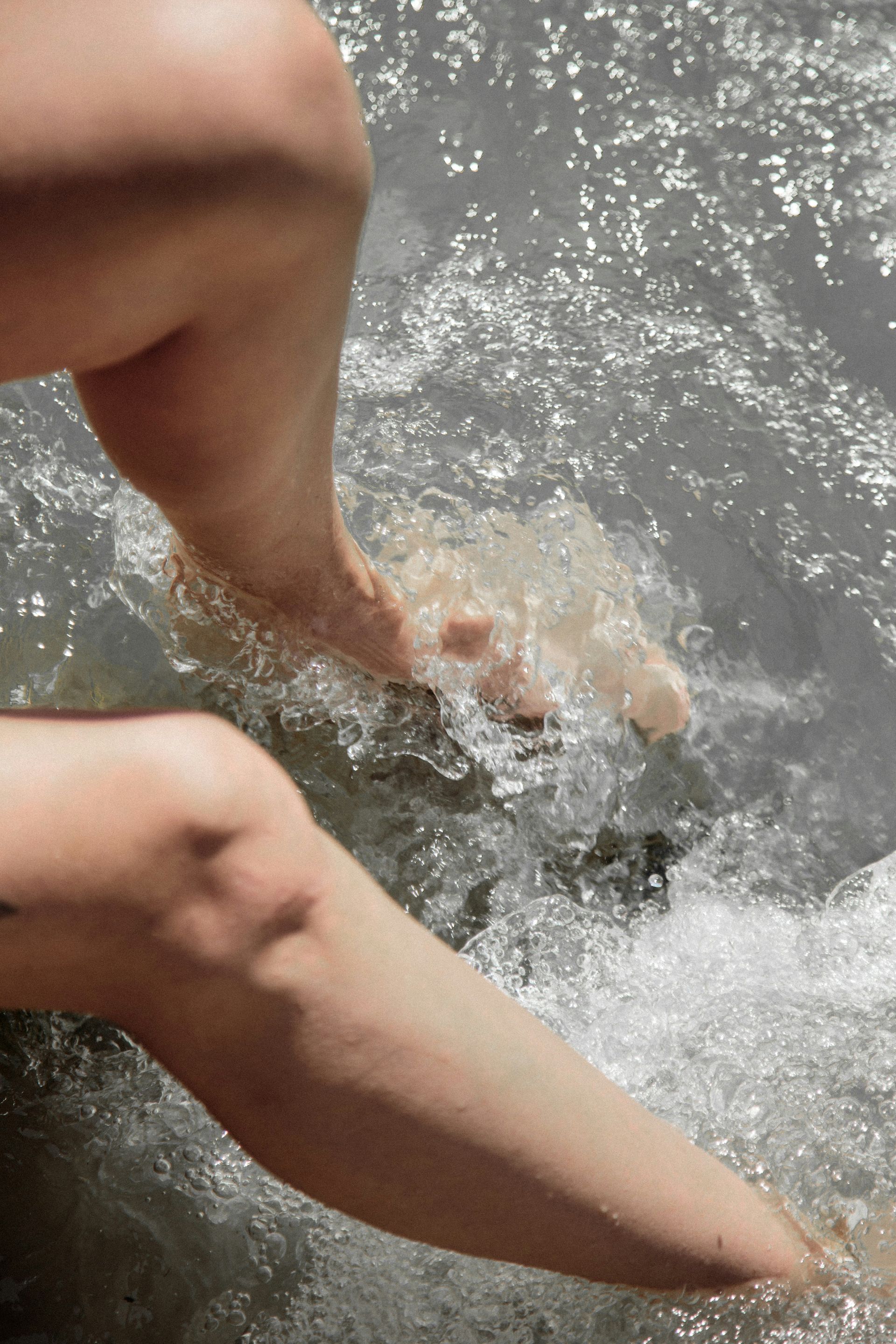 a close up of a person's feet in the water